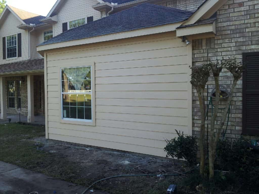 Exterior room addition with hardiplank siding and shingle roof.