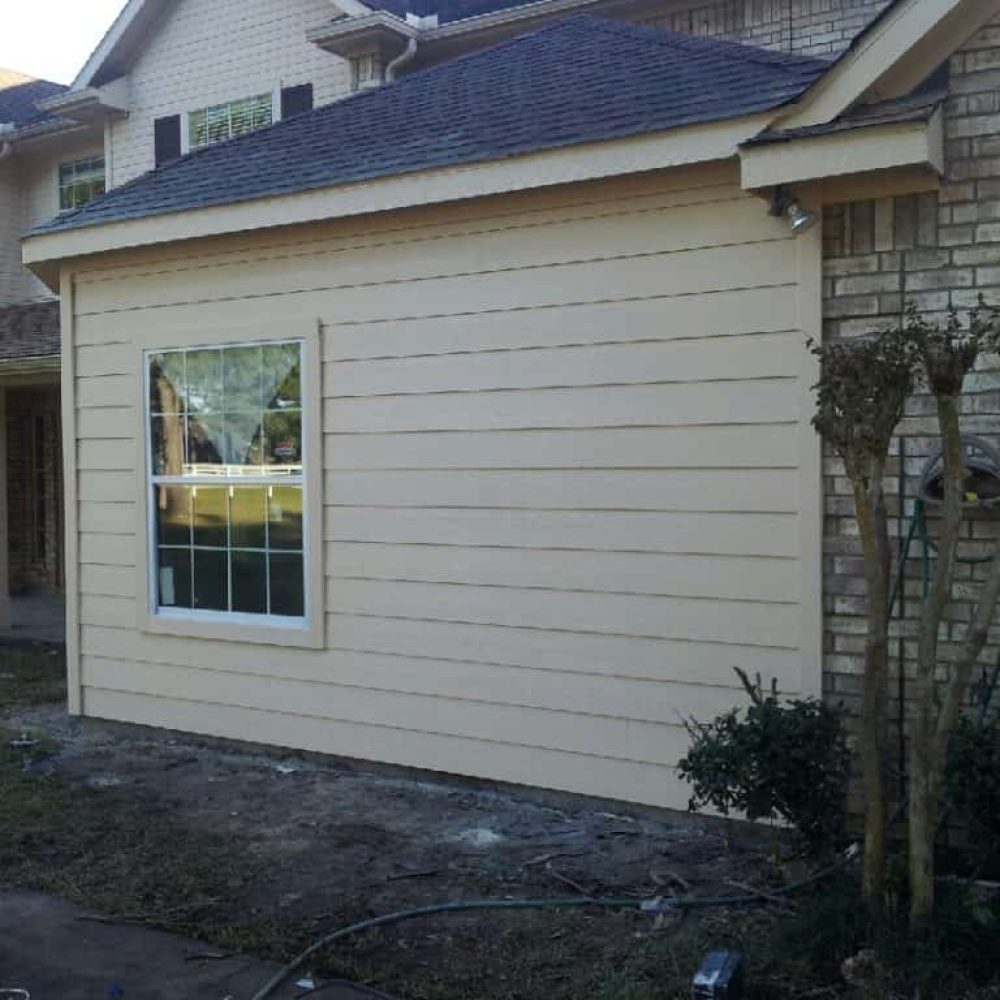 Exterior room addition with hardiplank siding and shingle roof.